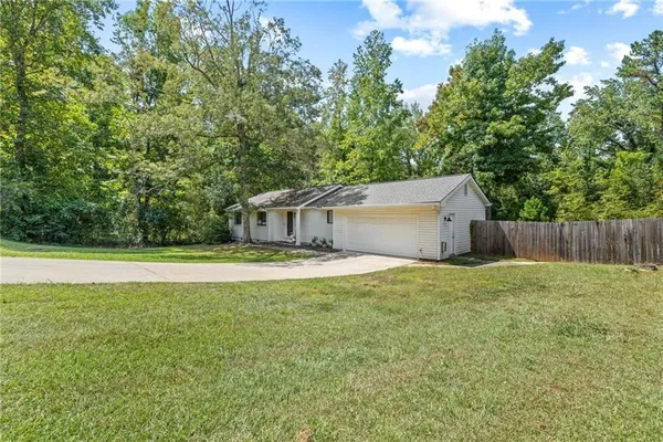 a living room with furniture a table and kitchen view