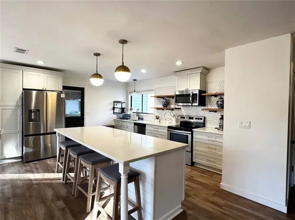 a kitchen with dining table and chairs