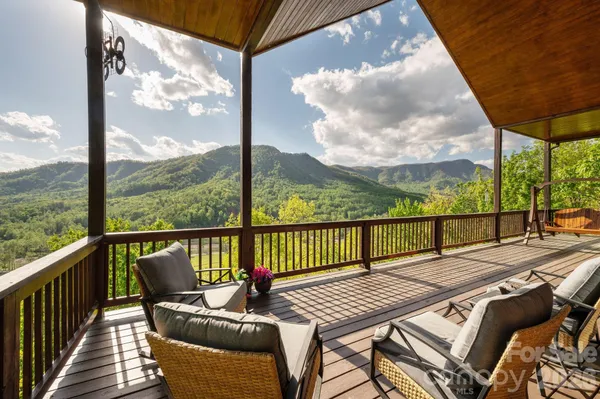a view of a balcony with floor to ceiling windows with wooden floor
