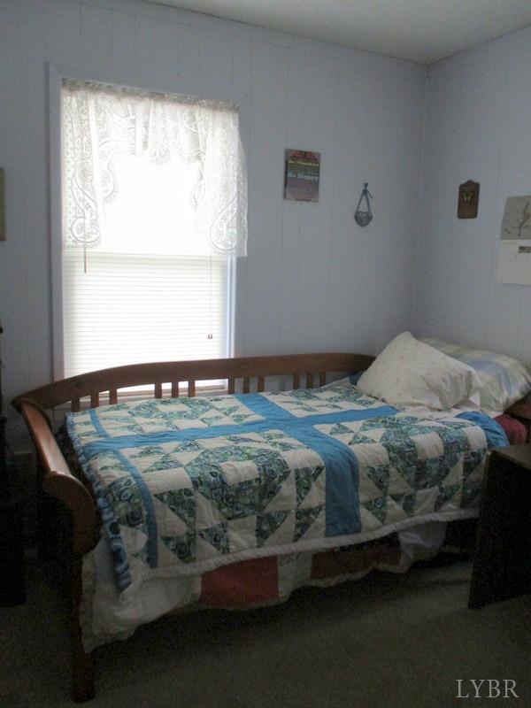 236 Jasper Wood Road Hurt, VA 24563 - Photo 13 of 28 a bedroom with a bed next to a window