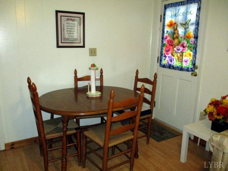 236 Jasper Wood Road Hurt, VA 24563 - Photo 8 of 28 a view of a dining room with furniture and wooden floor