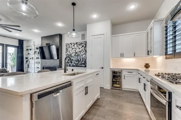 a kitchen with white cabinets and appliances