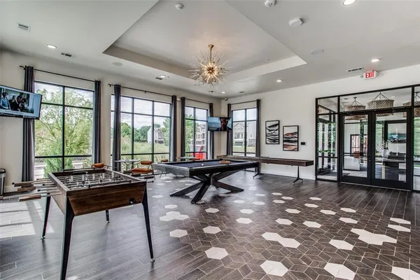 a living room with furniture and large windows