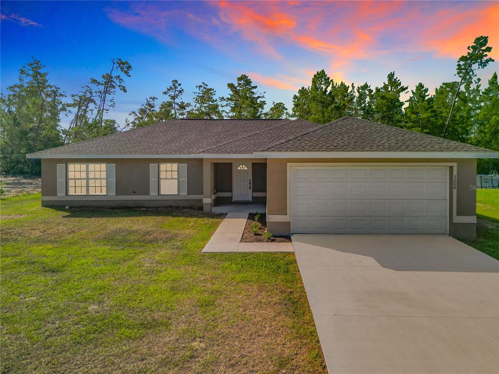 3006 Southwest 168th Loop Ocala, FL 34473 - Photo 1 of 1 a front view of a house with a yard