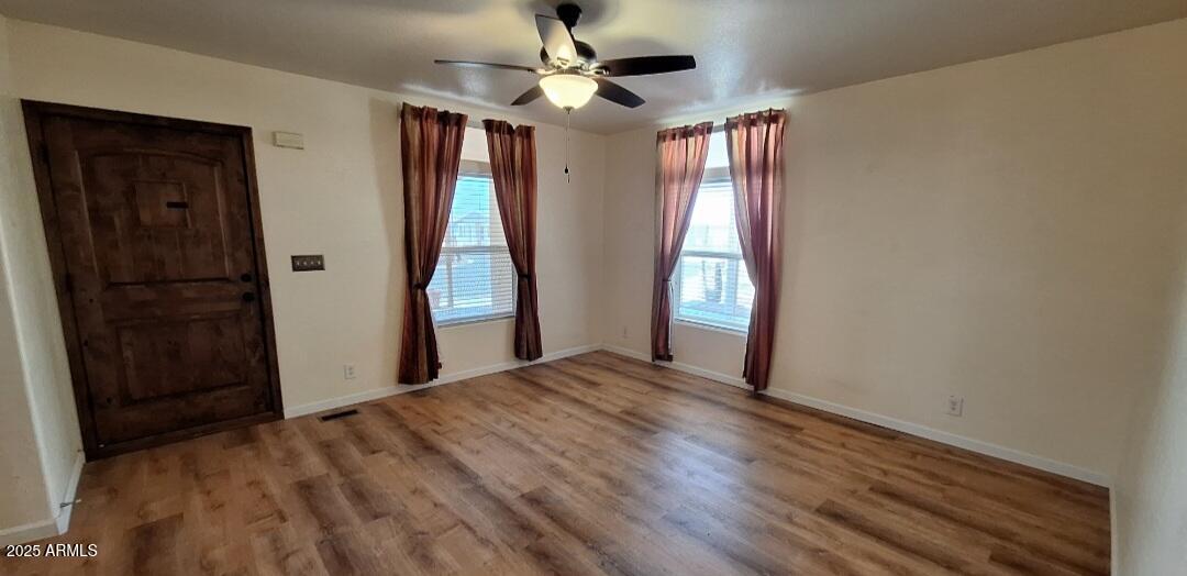 9351 East 28th Street East, Unit 212 Yuma, AZ 85365 - Photo 12 of 54 a view of an empty room with window and hardwood floor
