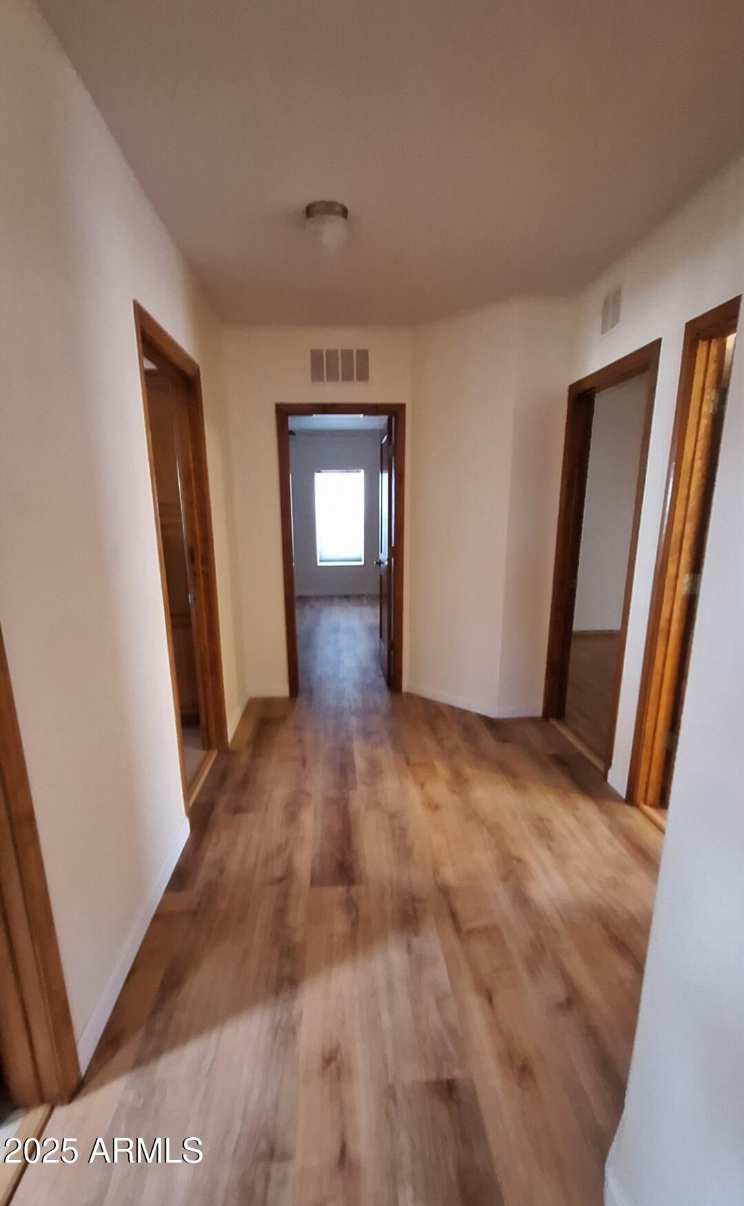 9351 East 28th Street East, Unit 212 Yuma, AZ 85365 - Photo 14 of 54 a view of a hallway with wooden floor and a livingroom