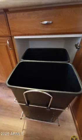 a large white kitchen with sink and a mirror