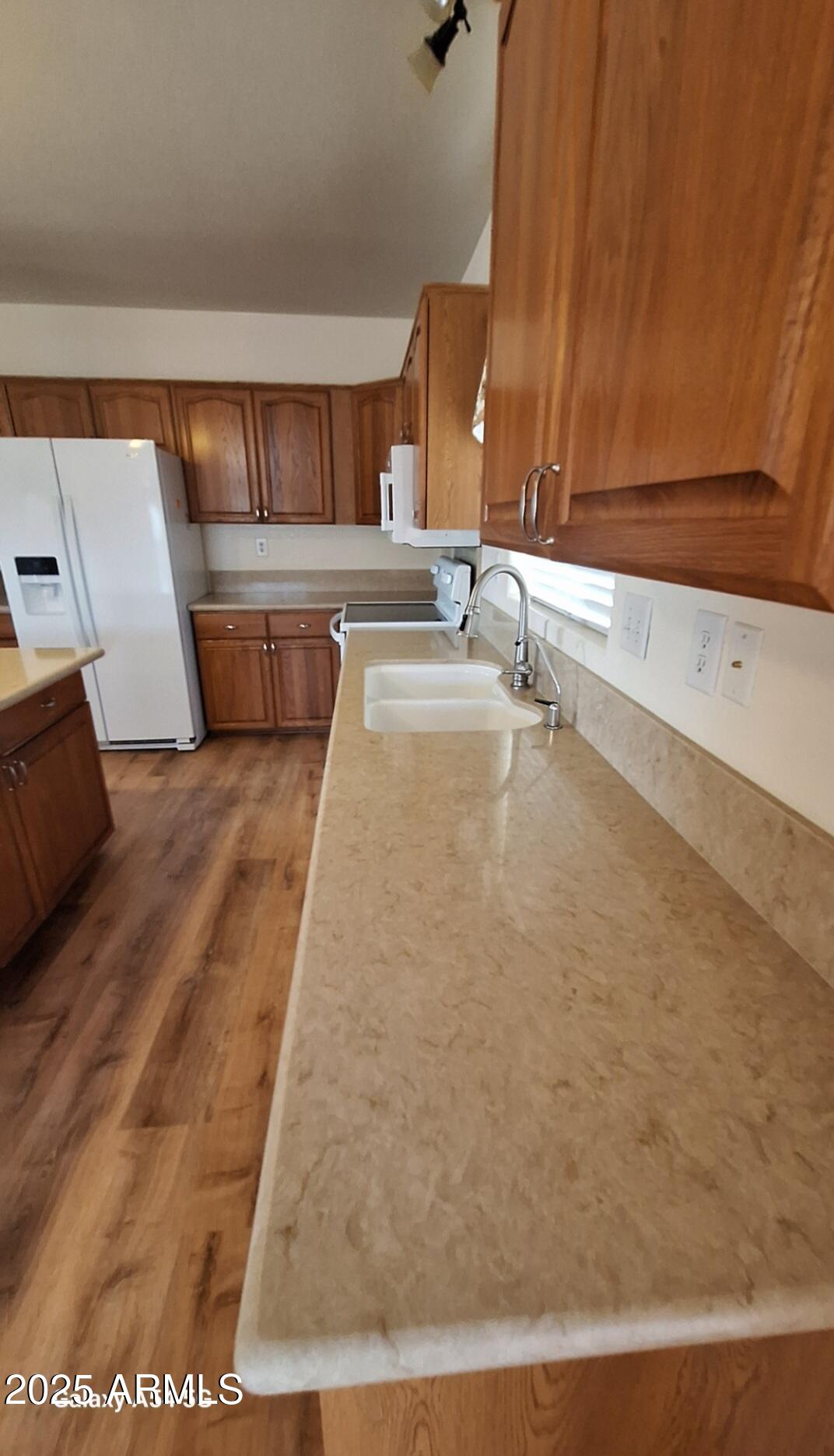 9351 East 28th Street East, Unit 212 Yuma, AZ 85365 - Photo 23 of 54 a large white kitchen with sink and a mirror