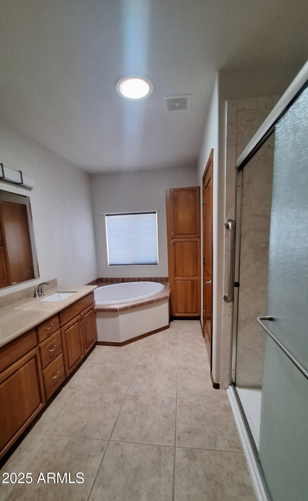 9351 East 28th Street East, Unit 212 Yuma, AZ 85365 - Photo 26 of 54 a spacious bathroom with a tub sink and mirror