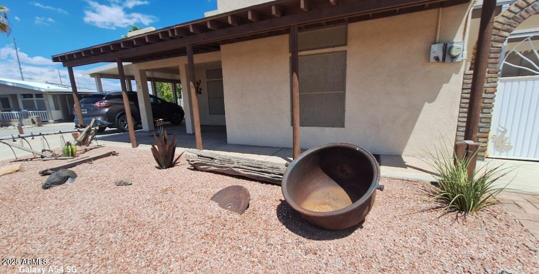 9351 East 28th Street East, Unit 212 Yuma, AZ 85365 - Photo 3 of 54 a front view of a house with patio