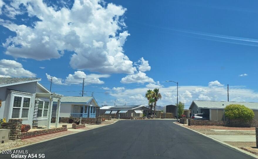 9351 East 28th Street East, Unit 212 Yuma, AZ 85365 - Photo 53 of 54 a view of a patio with dining table and chairs with wooden floor