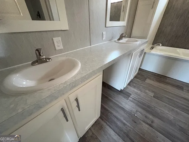 a bathroom with a double vanity sink and a mirror
