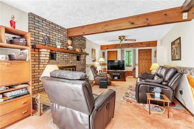 a living room with furniture fireplace and a flat screen tv