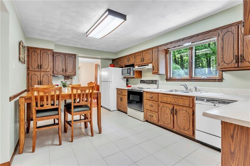 454 Cherokee Drive Butler, PA 16001 - Photo 13 of 29 a kitchen with stainless steel appliances granite countertop a table chairs sink and window