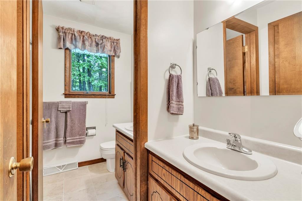 454 Cherokee Drive Butler, PA 16001 - Photo 24 of 29 a en suite bathroom with a sink and a mirror