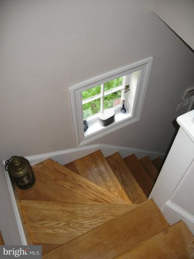 2447 Pickwick Road Baltimore, MD 21207 - Photo 1 of 28 a bed sitting in a bedroom next to a window