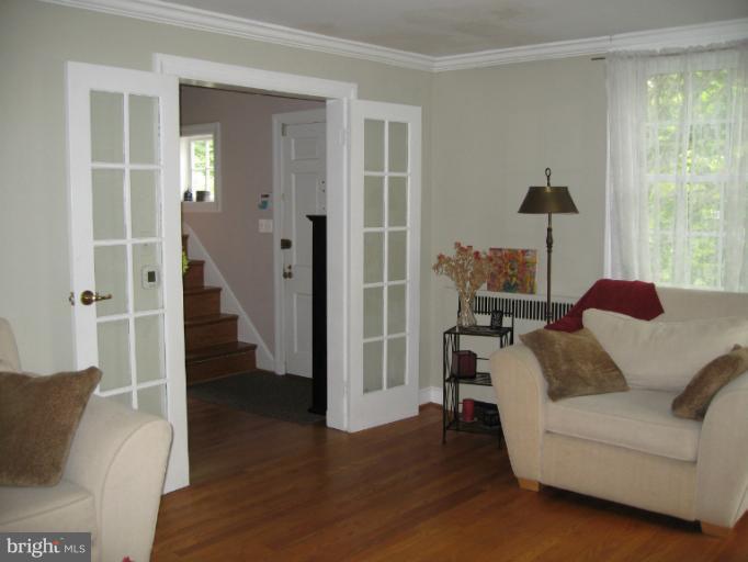 2447 Pickwick Road Baltimore, MD 21207 - Photo 22 of 28 a living room with furniture and a wooden floor