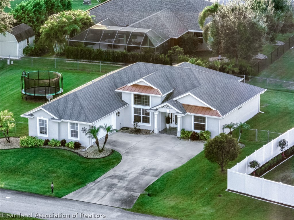 808 Spring Lake Boulevard Sebring, FL 33876 - Photo 1 of 38 a view of house with garden and tall trees