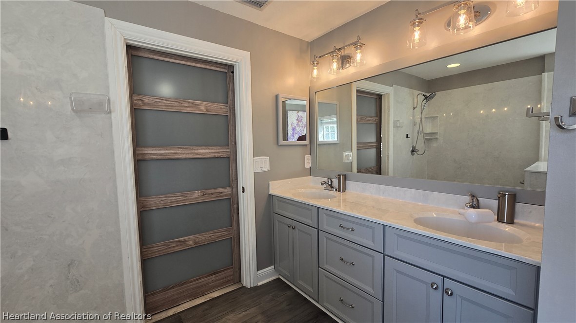 808 Spring Lake Boulevard Sebring, FL 33876 - Photo 14 of 38 a bathroom with a sink double vanity and a mirror
