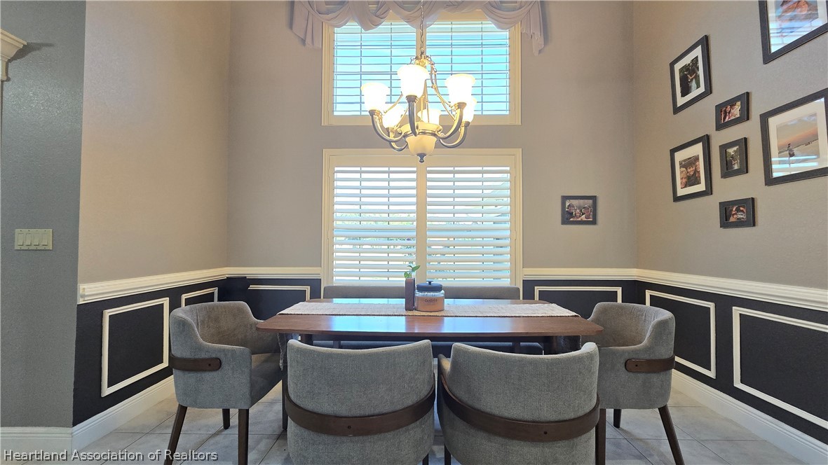 808 Spring Lake Boulevard Sebring, FL 33876 - Photo 16 of 38 a view of a dining room with furniture and window