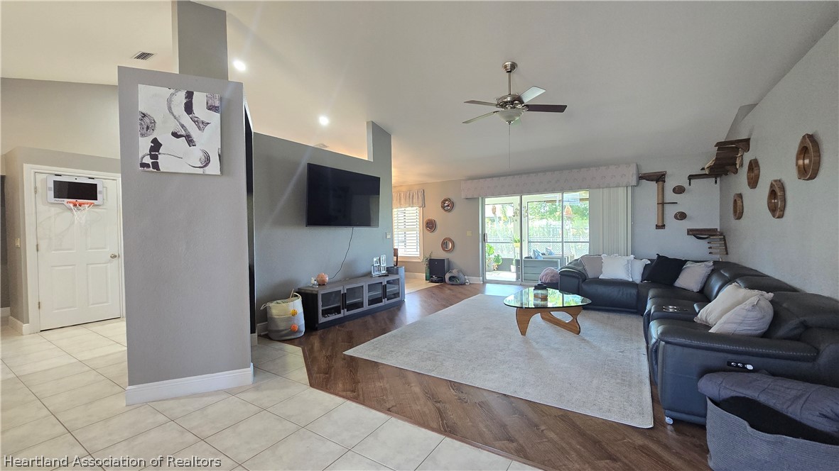 808 Spring Lake Boulevard Sebring, FL 33876 - Photo 17 of 38 a living room with furniture and a flat screen tv