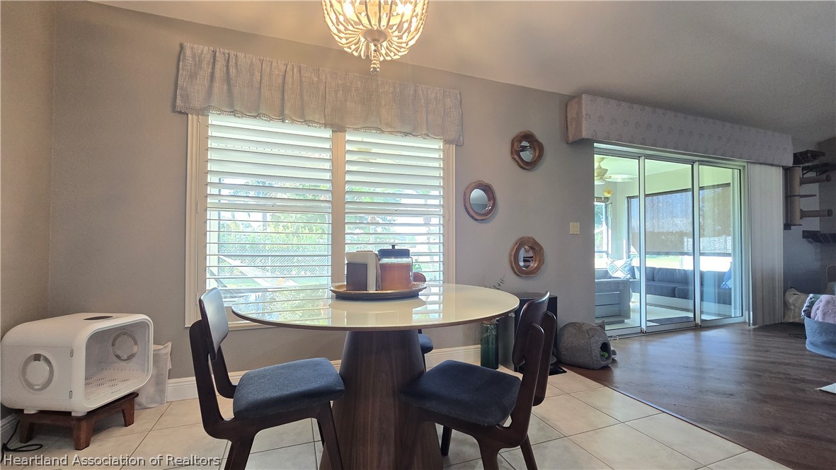 808 Spring Lake Boulevard Sebring, FL 33876 - Photo 21 of 38 a dining room with furniture and wooden floor