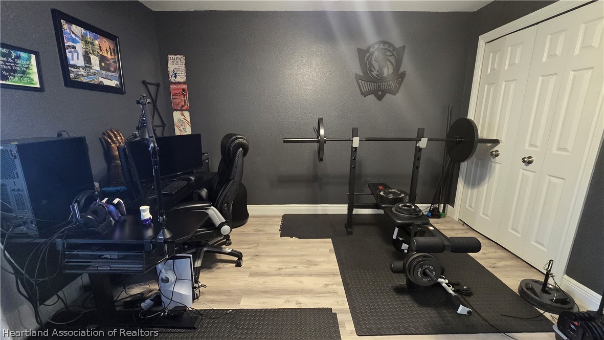 808 Spring Lake Boulevard Sebring, FL 33876 - Photo 25 of 38 a room with gym equipment and a view of living room