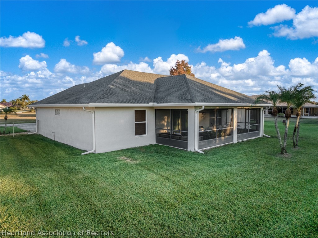 808 Spring Lake Boulevard Sebring, FL 33876 - Photo 28 of 38 a view of a house with a backyard