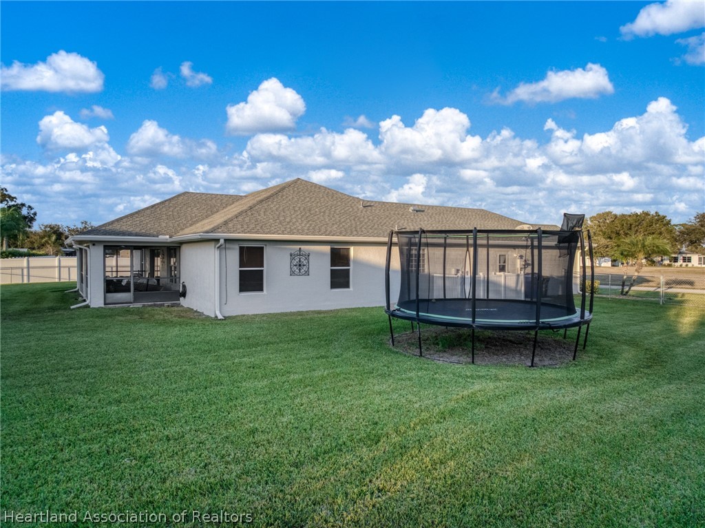 808 Spring Lake Boulevard Sebring, FL 33876 - Photo 29 of 38 a view of a house with a backyard