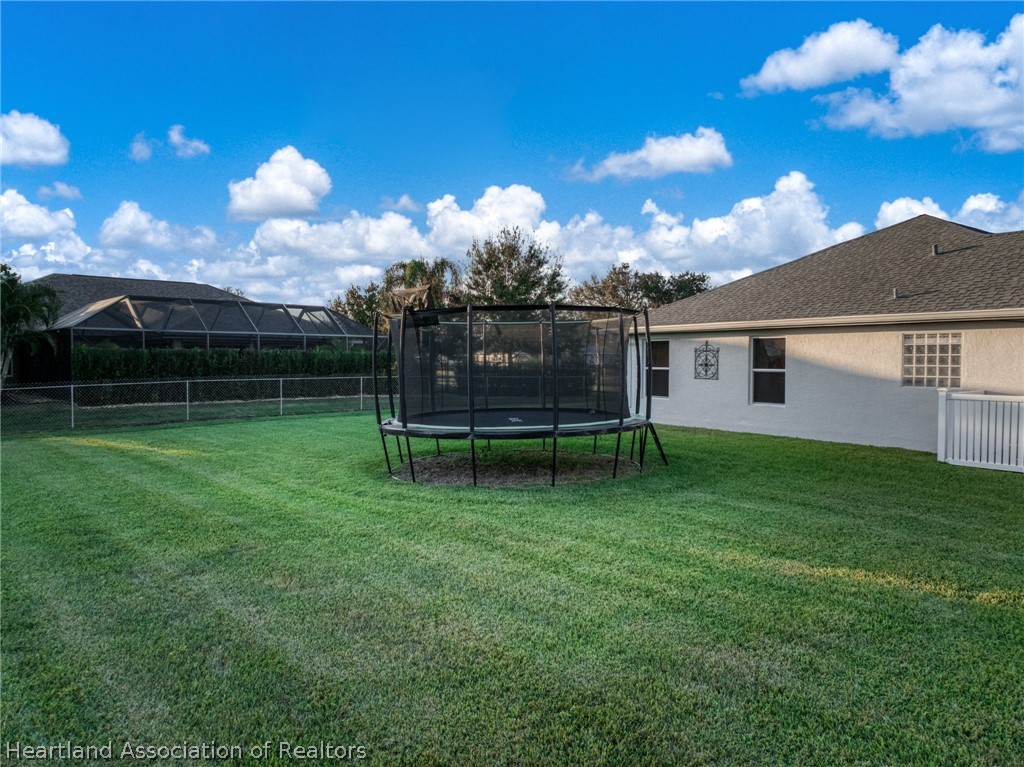 808 Spring Lake Boulevard Sebring, FL 33876 - Photo 30 of 38 a view of a house with a backyard