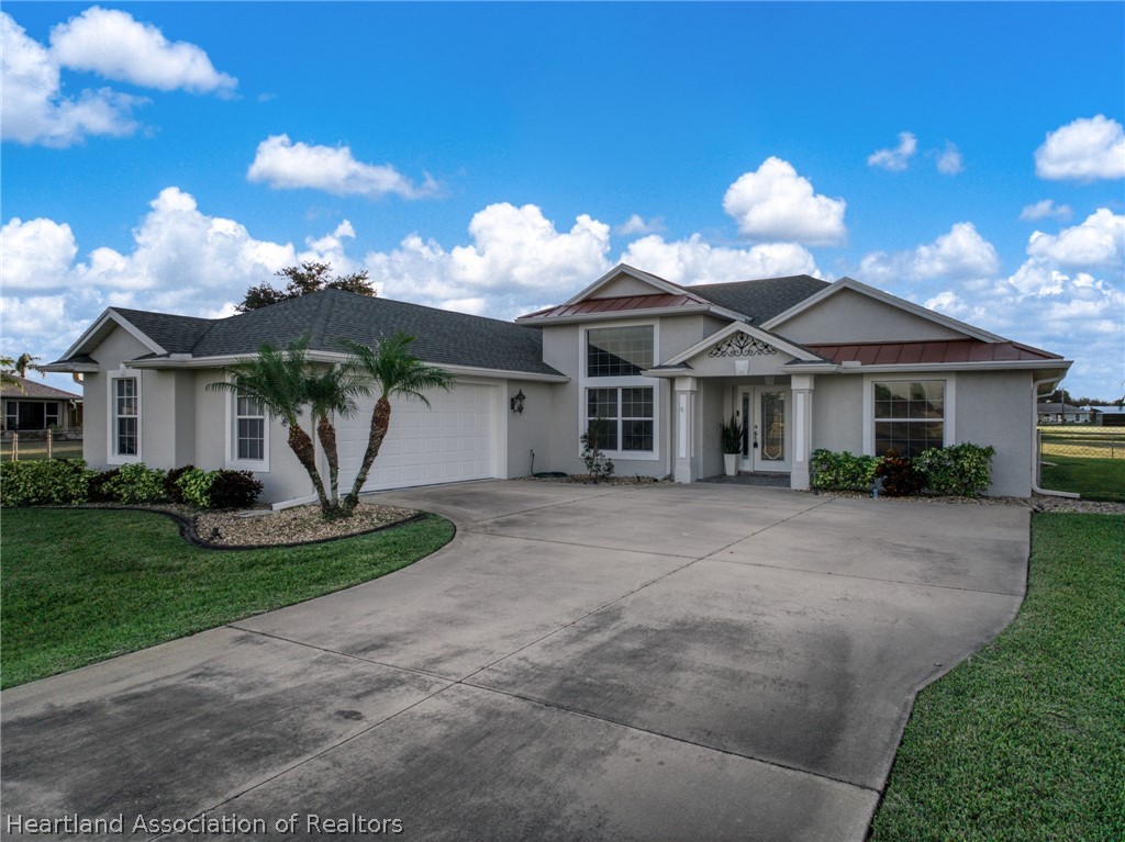 808 Spring Lake Boulevard Sebring, FL 33876 - Photo 36 of 38 a view of a house with a yard and potted plants
