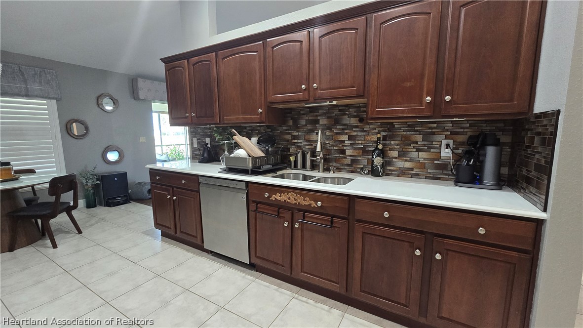 808 Spring Lake Boulevard Sebring, FL 33876 - Photo 8 of 38 a kitchen with stainless steel appliances granite countertop a sink a stove and cabinets