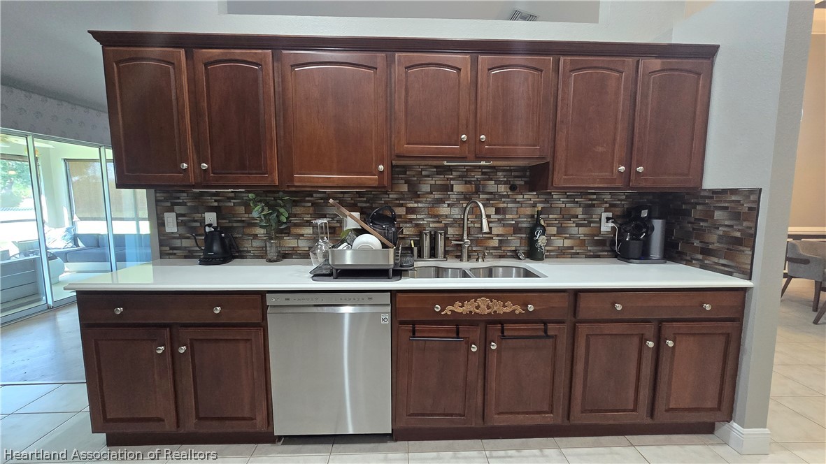 808 Spring Lake Boulevard Sebring, FL 33876 - Photo 9 of 38 a kitchen with granite countertop cabinets and sink