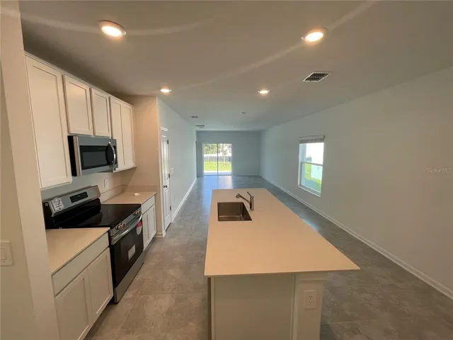 a kitchen with counter top space cabinets and appliances