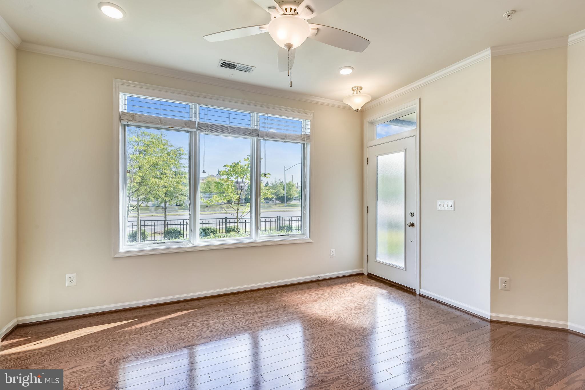 1508 Ribbon Limestone Terrace Southeast Leesburg, VA 20175 - Photo 15 of 79 a view of an empty room with a window and wooden floor