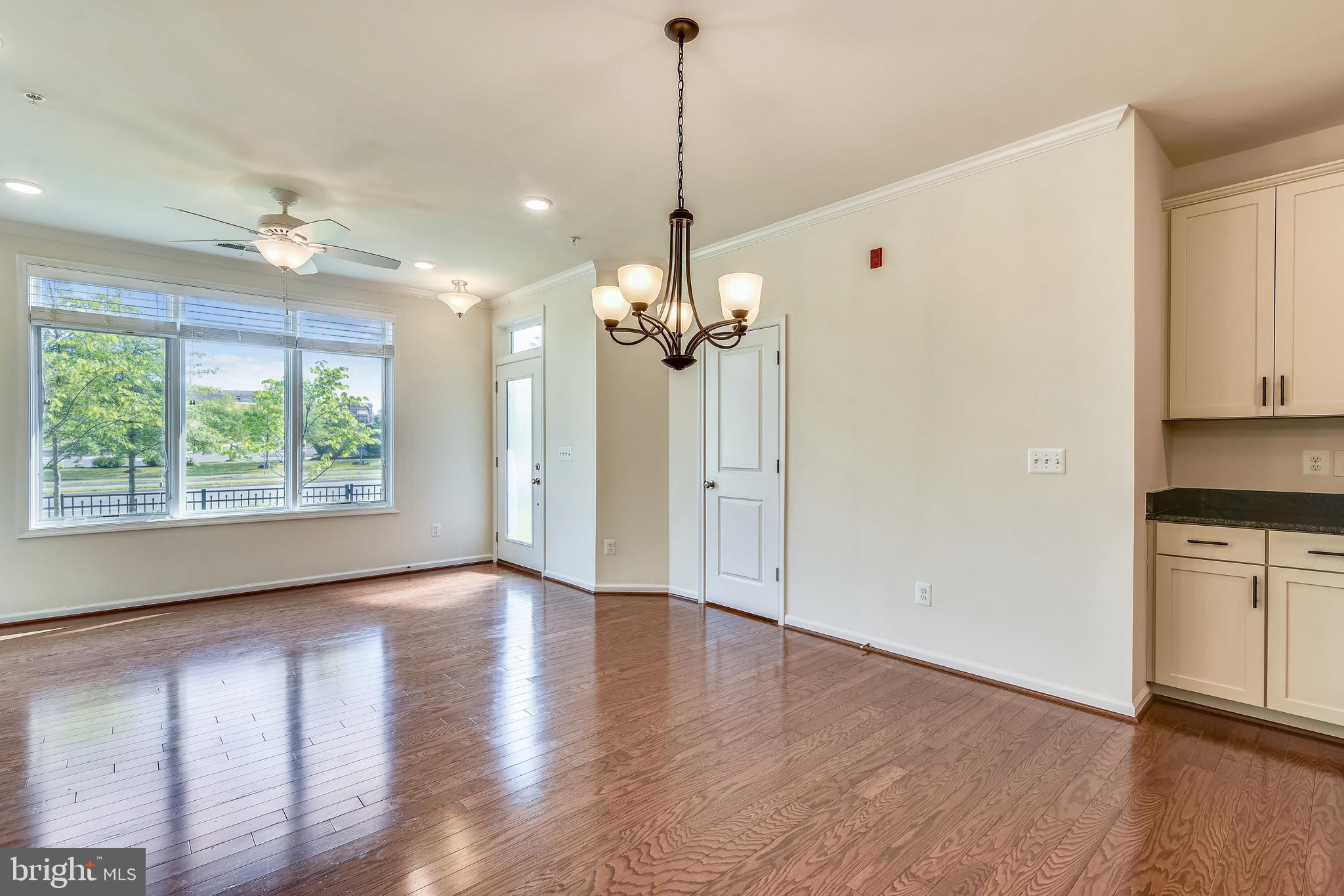 1508 Ribbon Limestone Terrace Southeast Leesburg, VA 20175 - Photo 16 of 79 a view of an empty room with window wooden floor and kitchen view