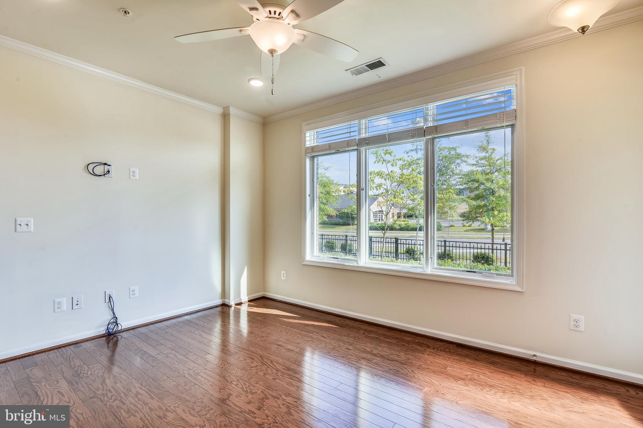 1508 Ribbon Limestone Terrace Southeast Leesburg, VA 20175 - Photo 17 of 79 a view of an empty room with wooden floor and a window