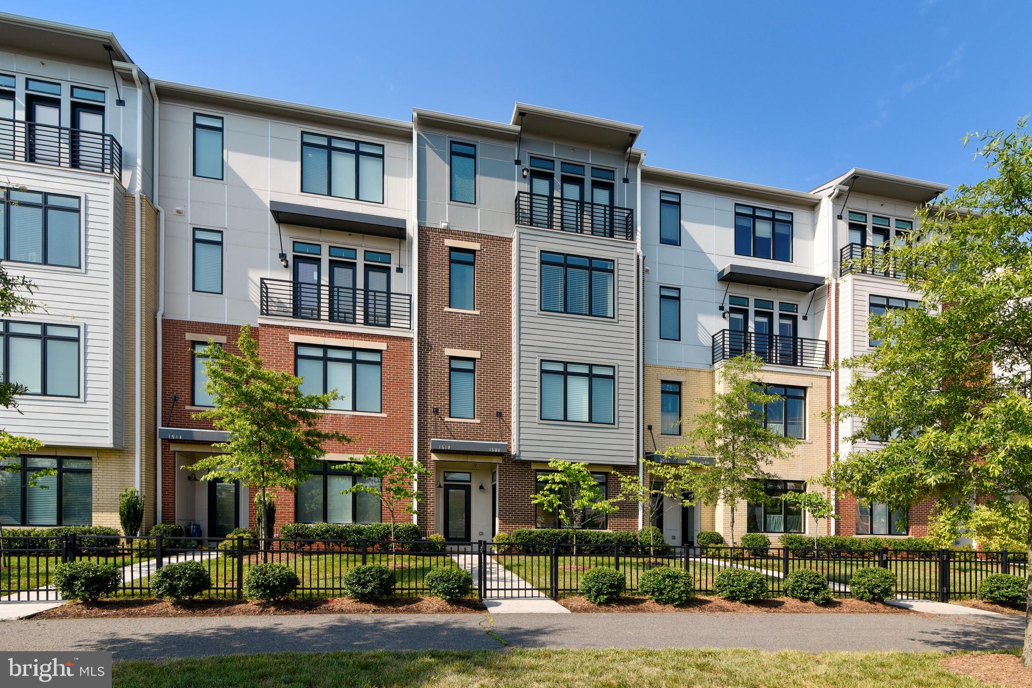 1508 Ribbon Limestone Terrace Southeast Leesburg, VA 20175 - Photo 4 of 79 a front view of a residential apartment building with a yard