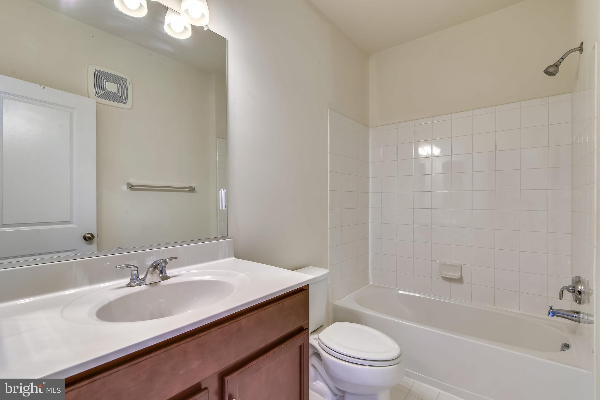1508 Ribbon Limestone Terrace Southeast Leesburg, VA 20175 - Photo 32 of 79 a bathroom with a granite countertop toilet a sink and a bathtub