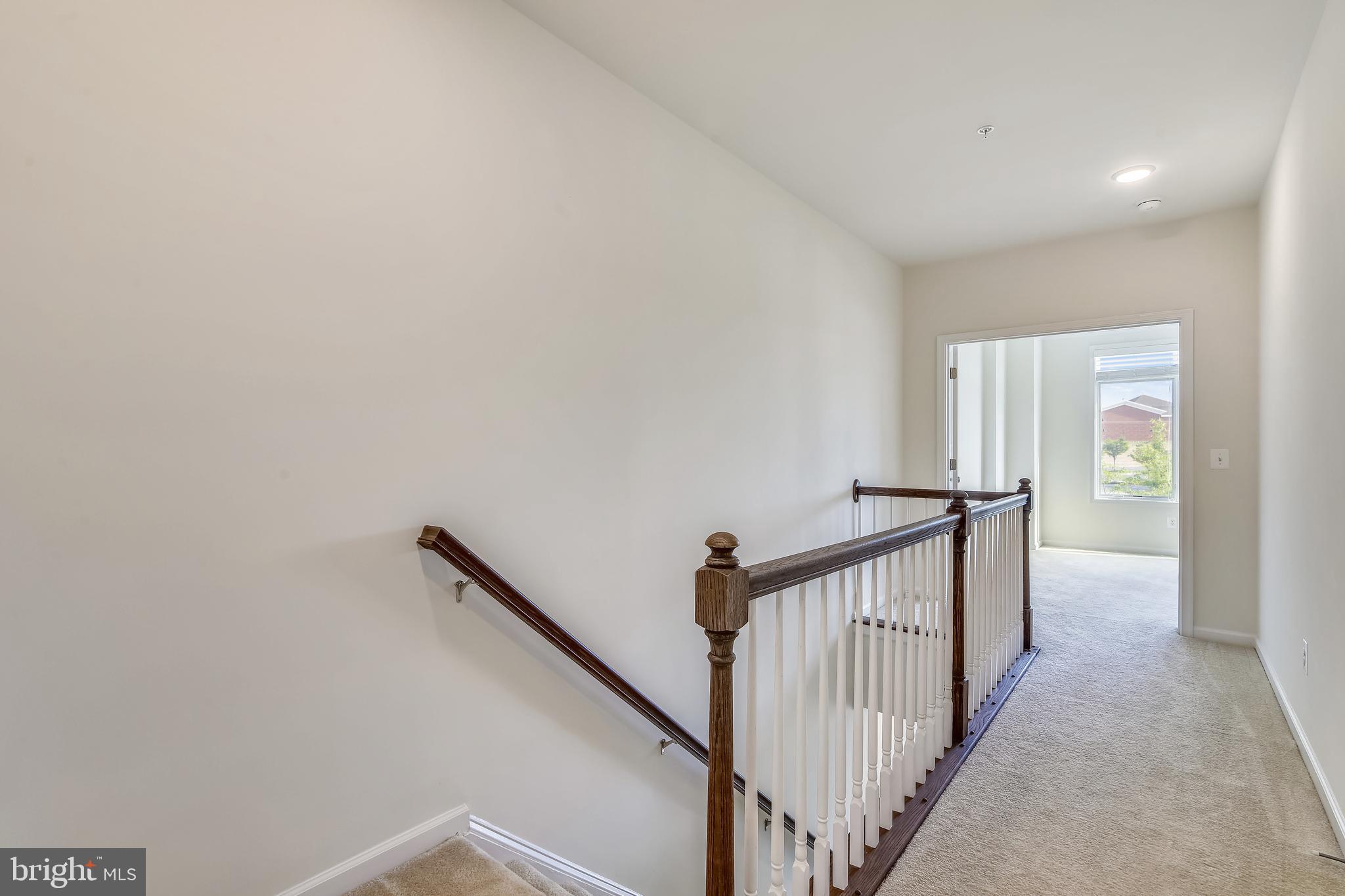 1508 Ribbon Limestone Terrace Southeast Leesburg, VA 20175 - Photo 40 of 79 a view of a hallway with wooden floor and entryway