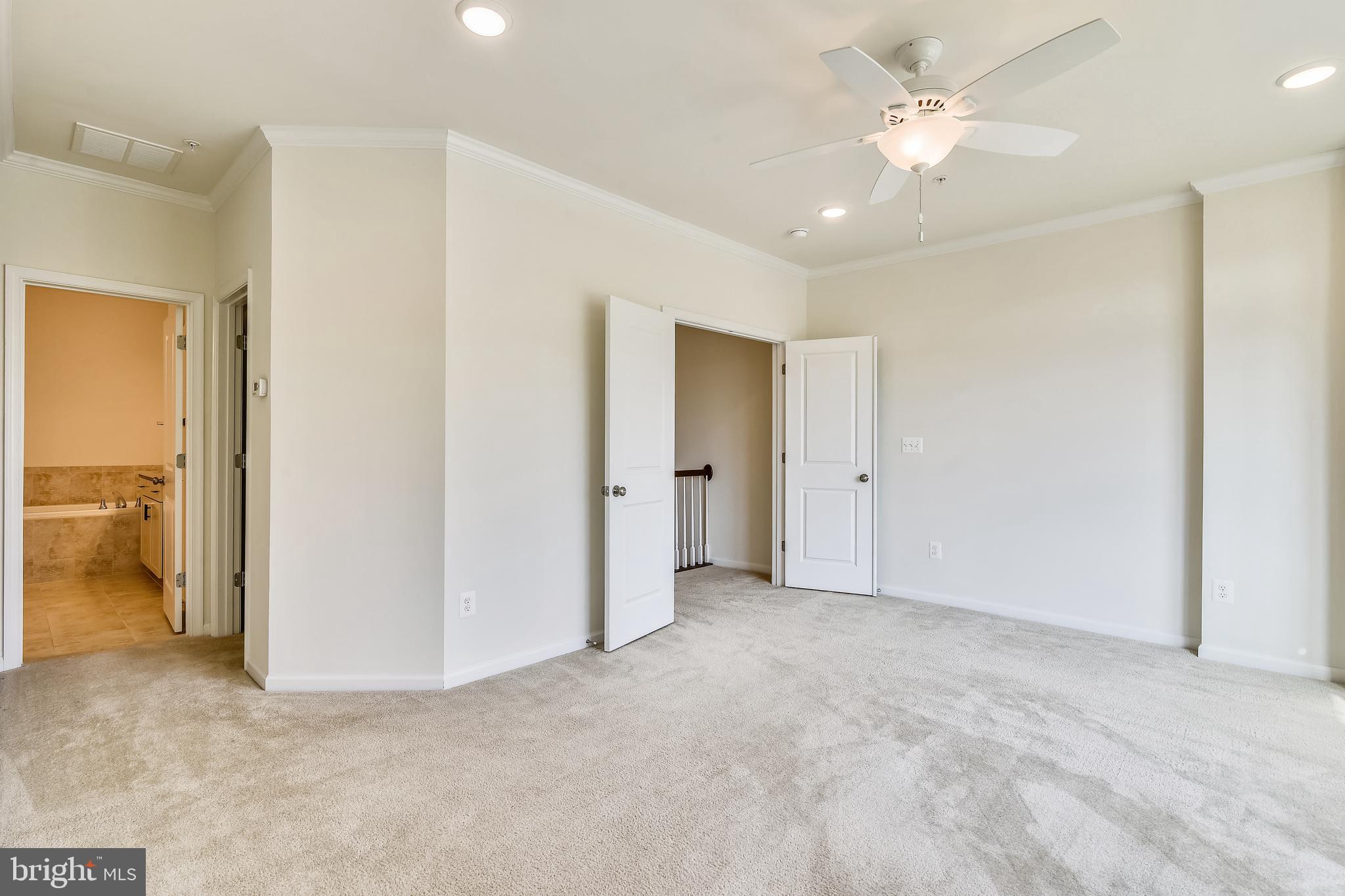 1508 Ribbon Limestone Terrace Southeast Leesburg, VA 20175 - Photo 43 of 79 an empty room with a bathroom and a ceiling fan