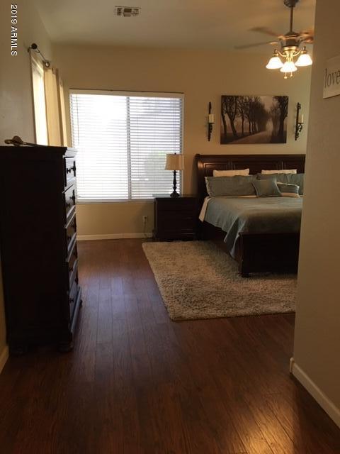 3443 East Rosa Lane Gilbert, AZ 85297 - Photo 17 of 53 a bedroom with a bed and wooden floor