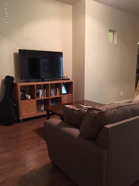 3443 East Rosa Lane Gilbert, AZ 85297 - Photo 27 of 53 a living room with furniture and a flat screen tv