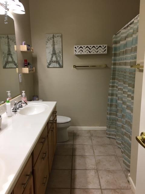 3443 East Rosa Lane Gilbert, AZ 85297 - Photo 31 of 53 a bathroom with a sink a toilet and a mirror