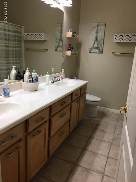 3443 East Rosa Lane Gilbert, AZ 85297 - Photo 32 of 53 a bathroom with a sink a toilet and mirror