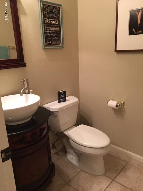 3443 East Rosa Lane Gilbert, AZ 85297 - Photo 34 of 53 a bathroom with a toilet a sink and mirror