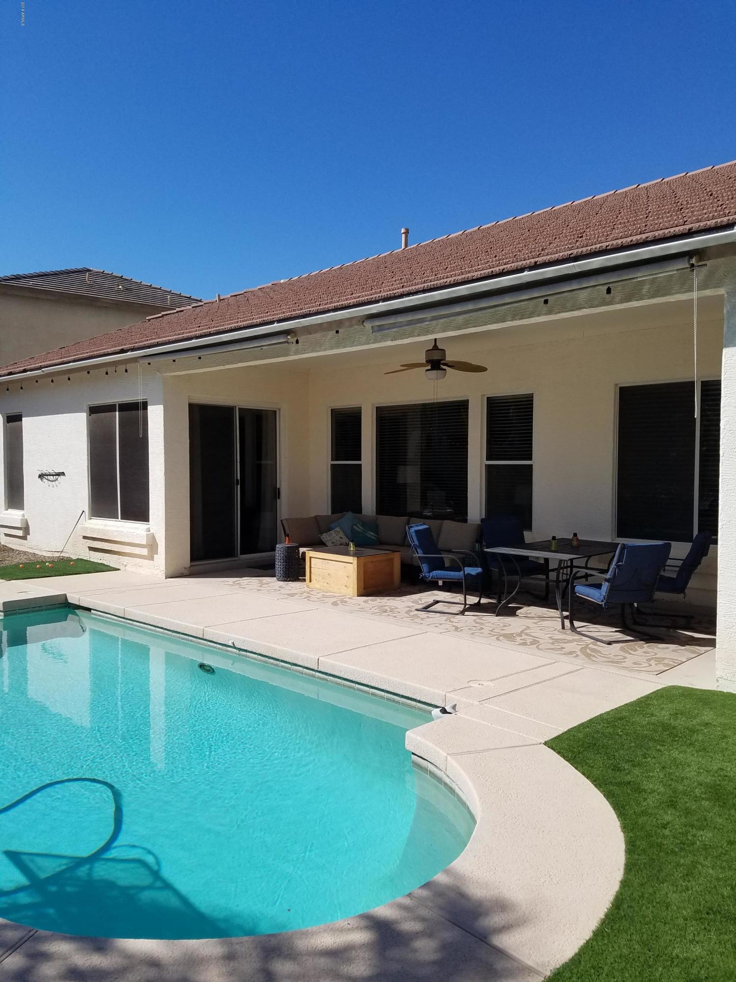 3443 East Rosa Lane Gilbert, AZ 85297 - Photo 37 of 53 a swimming pool with outdoor seating and yard