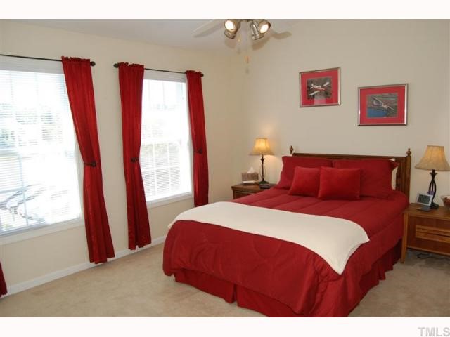 2031 Rivergate Road, Unit 107 Raleigh, NC 27614 - Photo 9 of 12 a bedroom with a bed and a large window