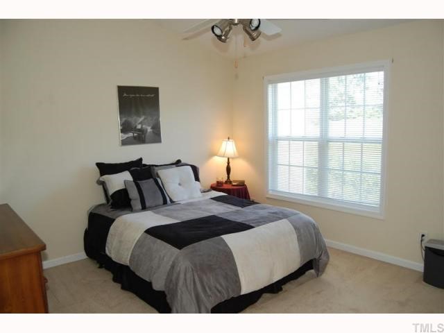 2031 Rivergate Road, Unit 107 Raleigh, NC 27614 - Photo 10 of 12 a bedroom with a bed and a window