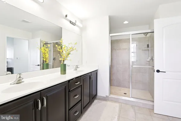 a bathroom with a shower sink and mirror